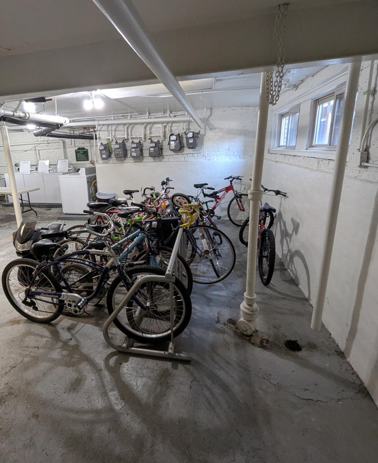A bike rack full of bicycles in a garage.